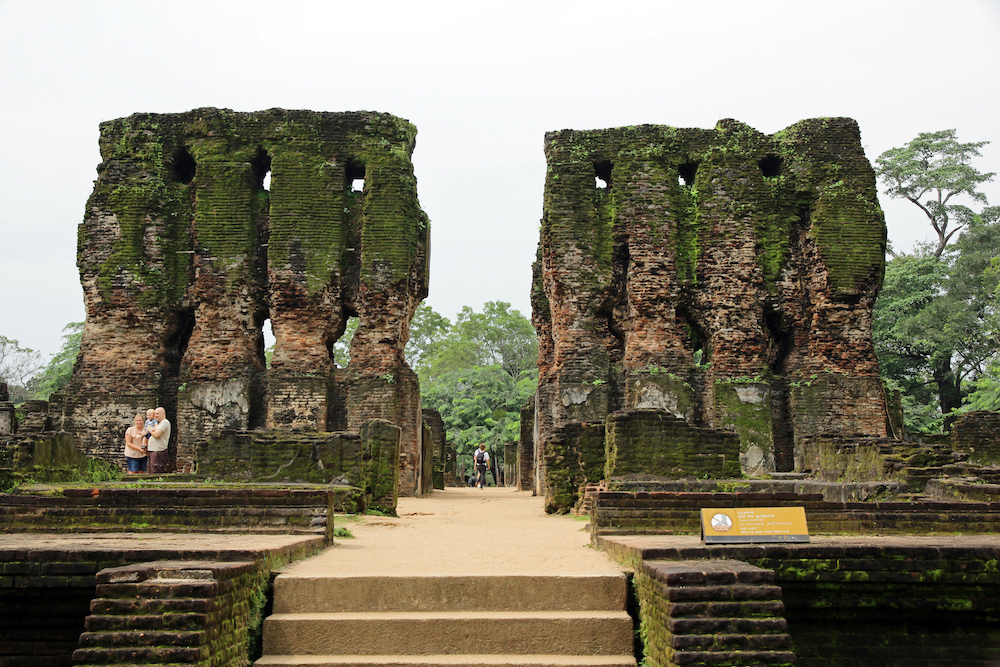 A picture of the Polonnaruwa ruins, a tall brick building with a walkway through the middle.