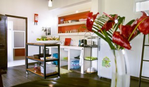 A picture of a kitchen with stove, kitchen table and kitchen island in the attic apartment.