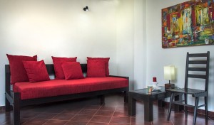 A picture of a sofa, table and chair in the apartment's living room.